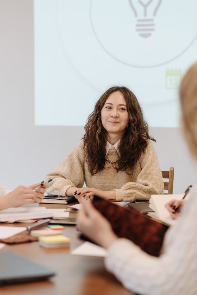 Professional woman in a business meeting setting, leading discussions indoors.